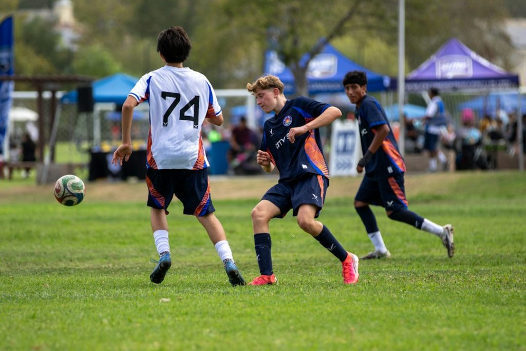 Youth soccer game with players on a green field