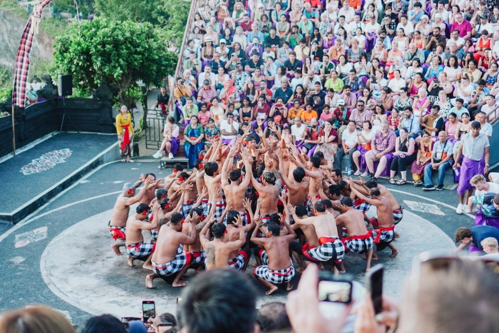 A traditional dance performance captivates a large crowd
