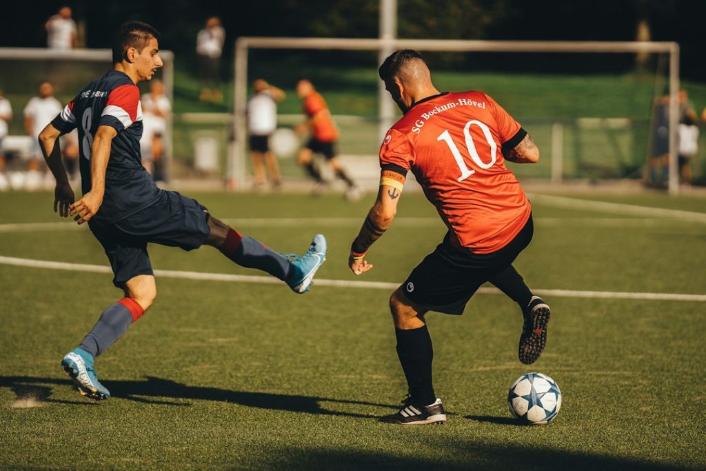 a couple of men playing a game of soccer