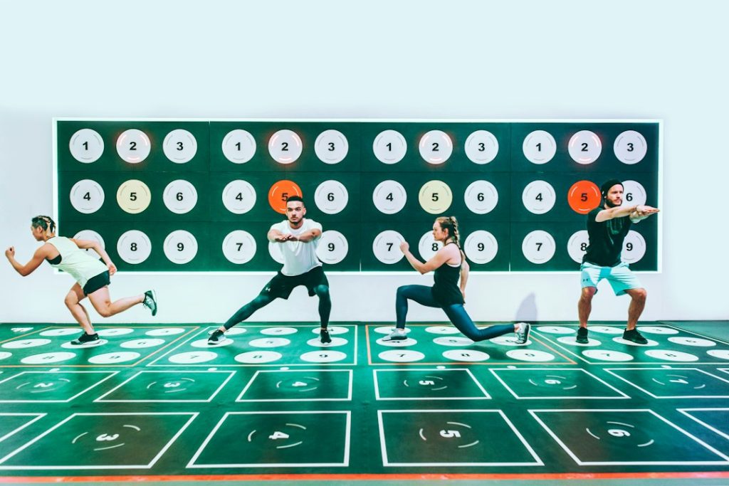 three men and woman doing exercises