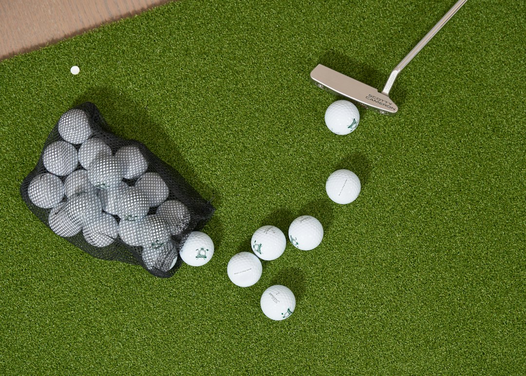 Golf balls spilling from a bag with a putter